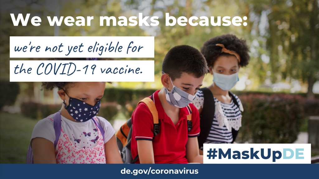 three children sitting on a bench reading homework papers while wearing masks outside. The graphic elements read: "We wear masks because: we're not yet eligible for the COVID-19 vaccine."