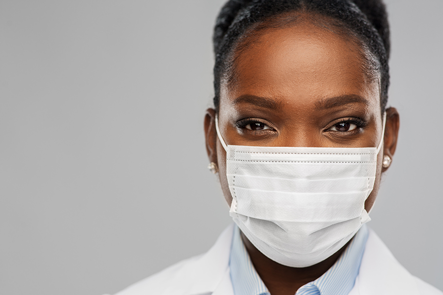 Photo of a female doctor with a mask on.